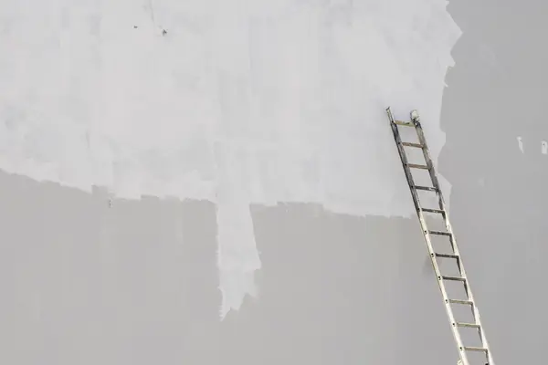 Exterior painting in Syracuse: ladder against a freshly primed wall